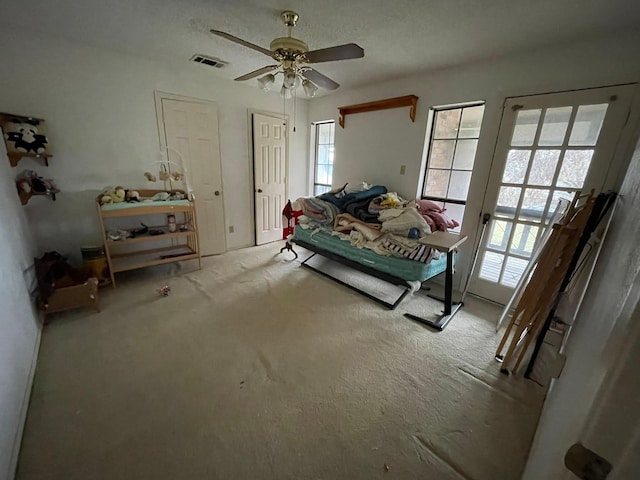 bedroom with ceiling fan and light colored carpet