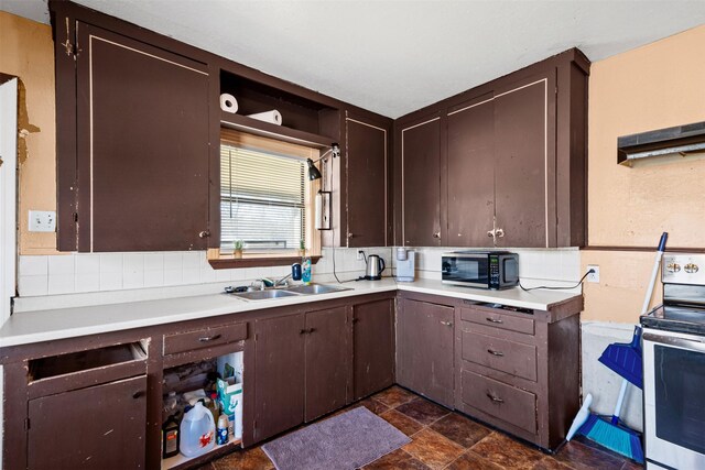 kitchen with electric stove, sink, and dark brown cabinets