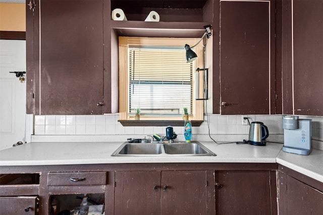 kitchen featuring tasteful backsplash, sink, and dark brown cabinets