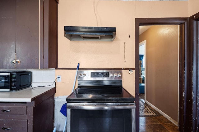 kitchen featuring tasteful backsplash, dark brown cabinets, range hood, and stainless steel electric range