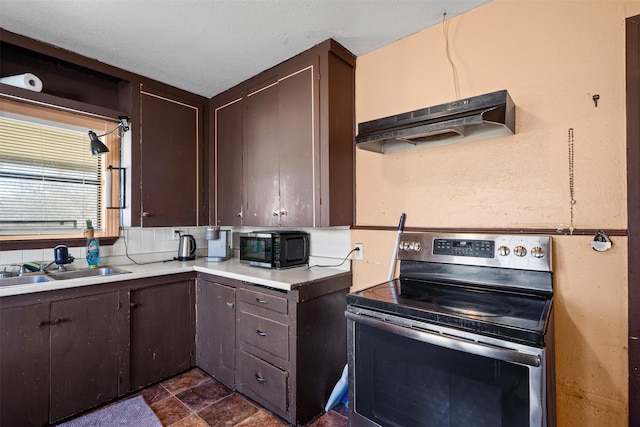 kitchen featuring dark brown cabinetry, sink, decorative backsplash, and stainless steel electric stove