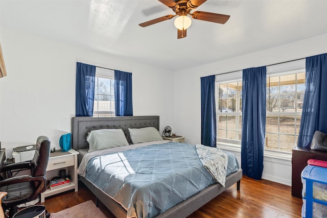 bedroom with ceiling fan and dark hardwood / wood-style flooring