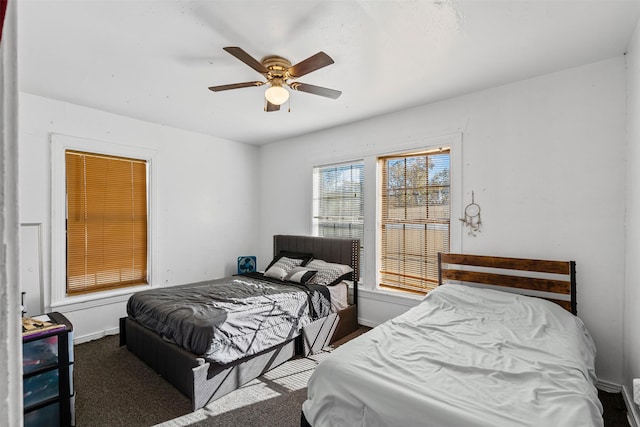 bedroom featuring ceiling fan and dark colored carpet