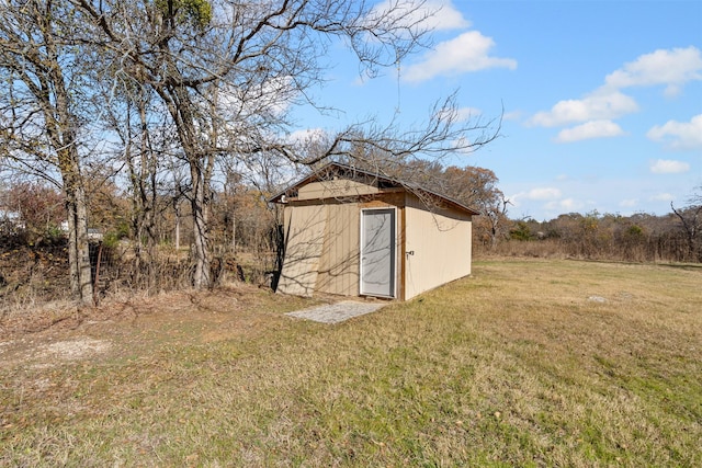 view of outbuilding with a yard