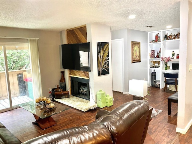 living room featuring dark hardwood / wood-style flooring and a textured ceiling