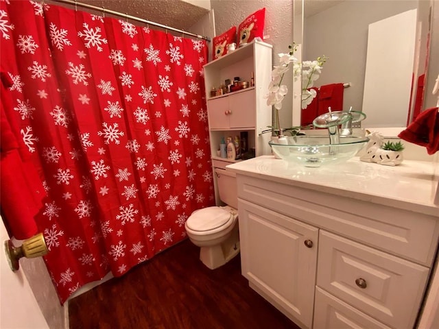 bathroom featuring hardwood / wood-style flooring, vanity, and toilet