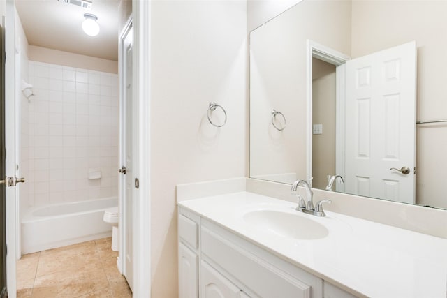 full bathroom featuring vanity, tiled shower / bath, tile patterned floors, and toilet