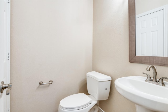 bathroom featuring sink and toilet