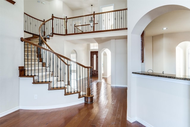 entrance foyer with hardwood / wood-style flooring and a high ceiling