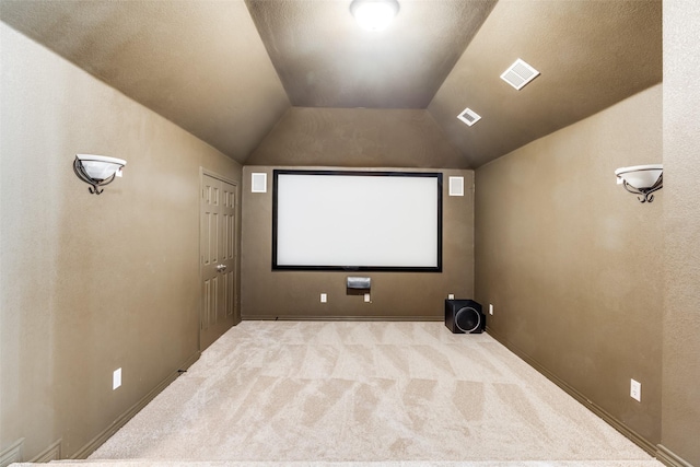 home theater with light colored carpet and lofted ceiling