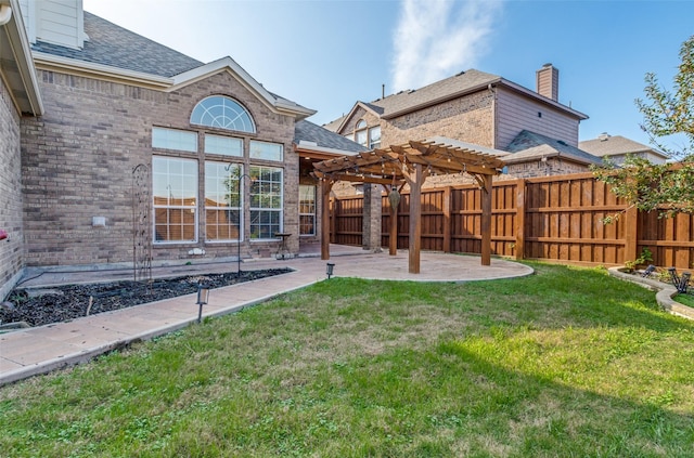 back of house with a patio, a lawn, and a pergola