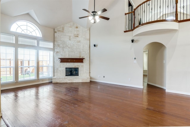 unfurnished living room with ceiling fan, plenty of natural light, and dark hardwood / wood-style flooring