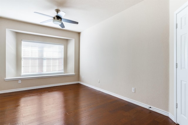 spare room with dark wood-type flooring and ceiling fan