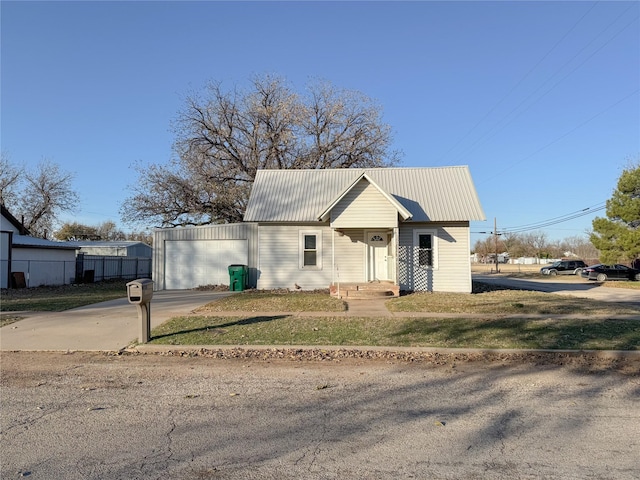 view of front of house with a garage and a front lawn