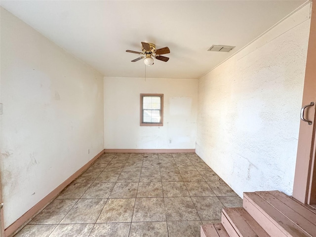 spare room featuring light tile patterned flooring and ceiling fan