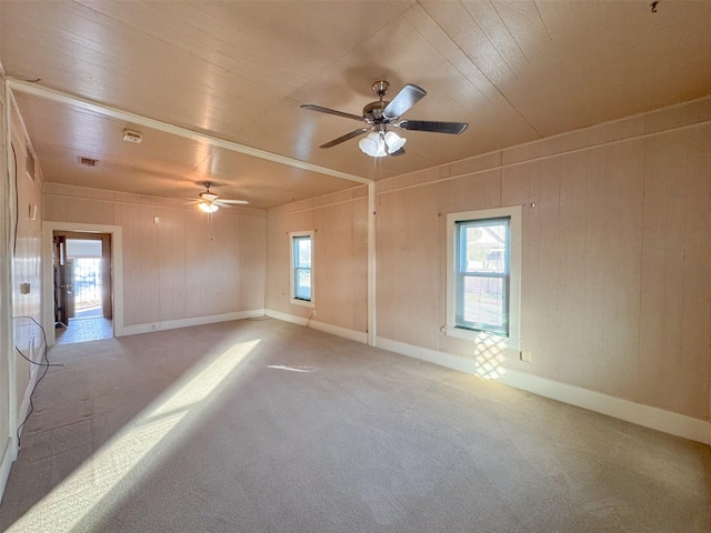 carpeted empty room featuring wood ceiling and ceiling fan