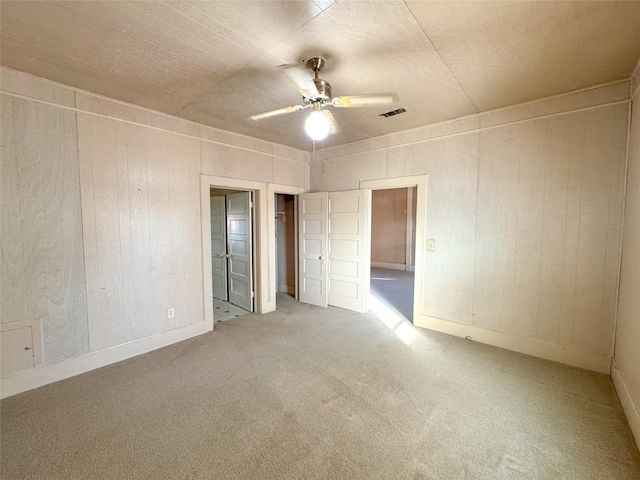 empty room with carpet floors and ceiling fan