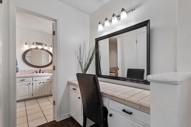 bathroom with vanity, decorative backsplash, tile patterned floors, and a textured ceiling