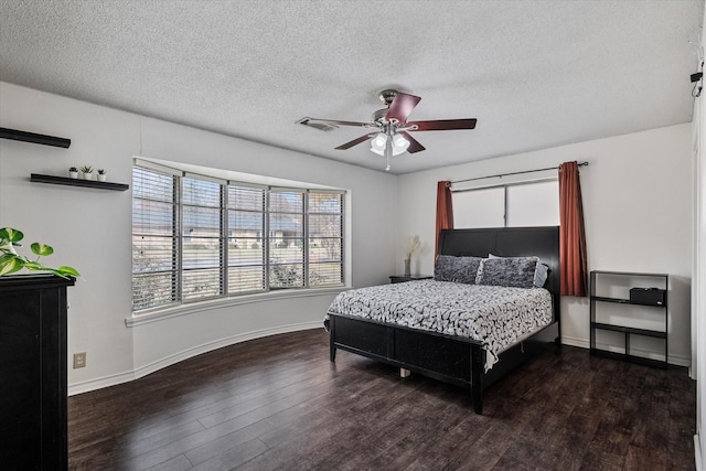 bedroom featuring ceiling fan, a textured ceiling, and dark hardwood / wood-style flooring