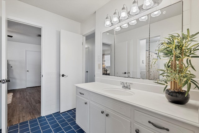 bathroom with hardwood / wood-style flooring, a textured ceiling, and vanity