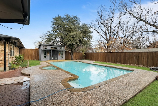 view of pool with a patio and an outbuilding