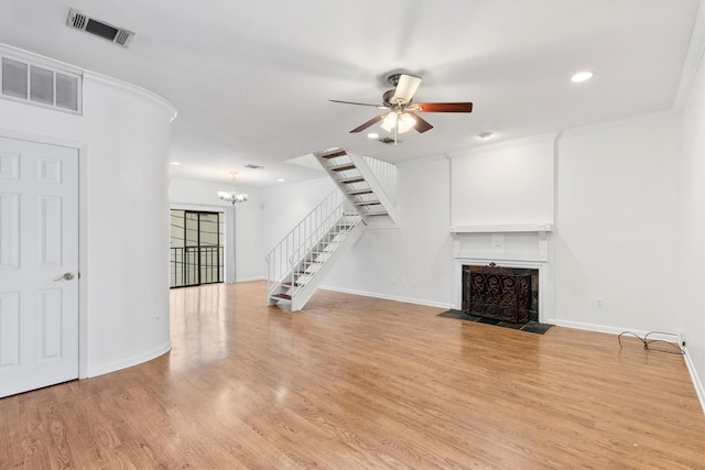 unfurnished living room featuring light hardwood / wood-style flooring, ceiling fan with notable chandelier, and ornamental molding