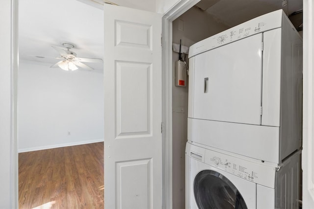 washroom featuring hardwood / wood-style floors, ceiling fan, and stacked washing maching and dryer