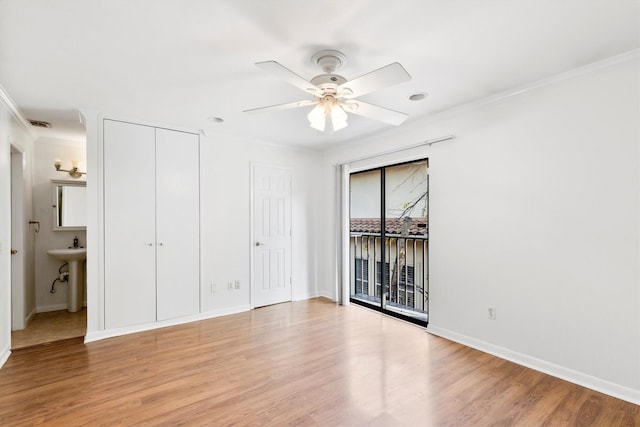 unfurnished bedroom featuring access to exterior, ceiling fan, light hardwood / wood-style flooring, ensuite bathroom, and ornamental molding