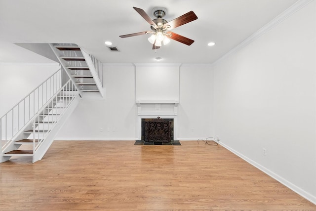 unfurnished living room with crown molding, ceiling fan, and light hardwood / wood-style floors