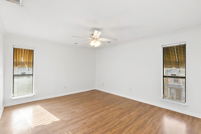 unfurnished room with crown molding, ceiling fan, and wood-type flooring