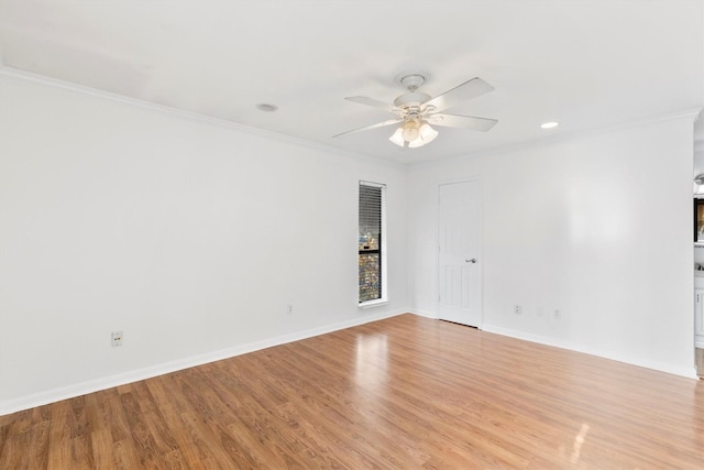 empty room with crown molding, ceiling fan, and light hardwood / wood-style floors