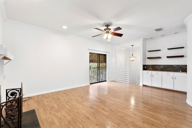 unfurnished living room with ceiling fan, light hardwood / wood-style floors, and crown molding