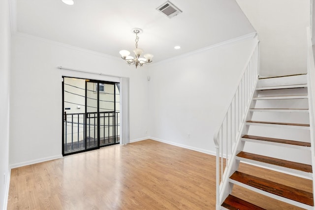 interior space with crown molding, a chandelier, and light wood-type flooring