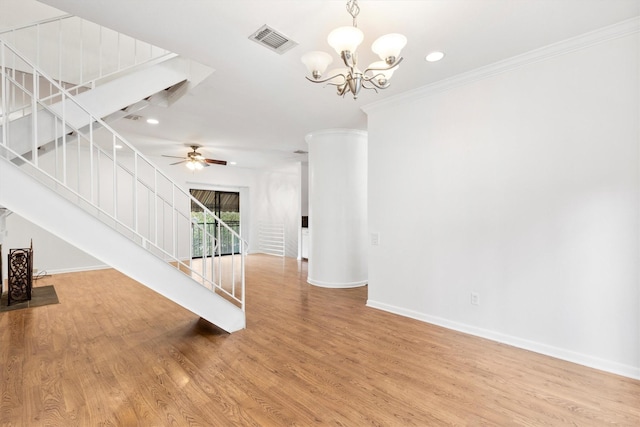 unfurnished living room featuring hardwood / wood-style floors, ceiling fan with notable chandelier, and crown molding