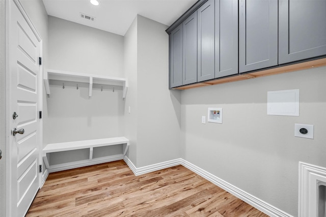 washroom featuring washer hookup, cabinets, hookup for an electric dryer, and light wood-type flooring