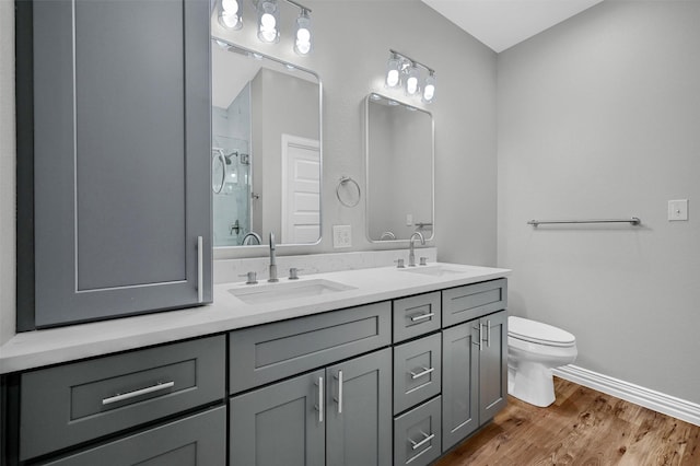 bathroom with vanity, hardwood / wood-style floors, toilet, and walk in shower