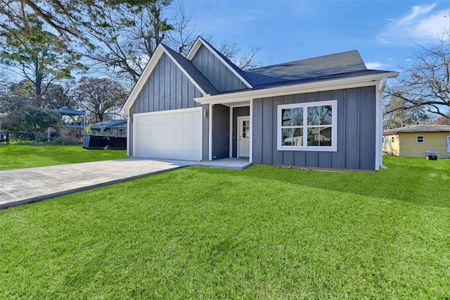 view of front of house with a front yard and a garage