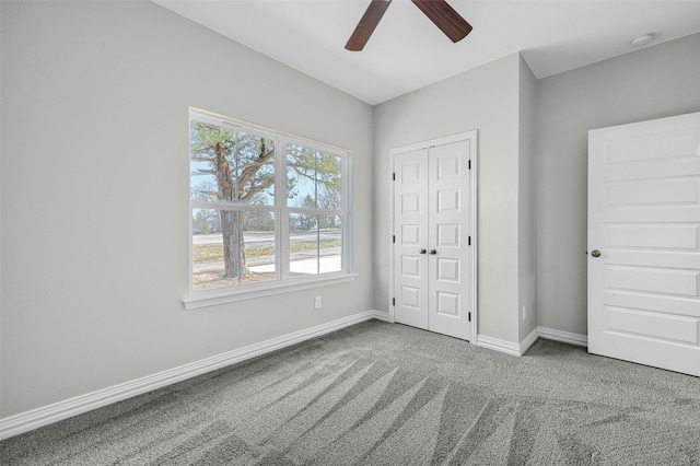 unfurnished bedroom featuring ceiling fan, carpet flooring, and a closet