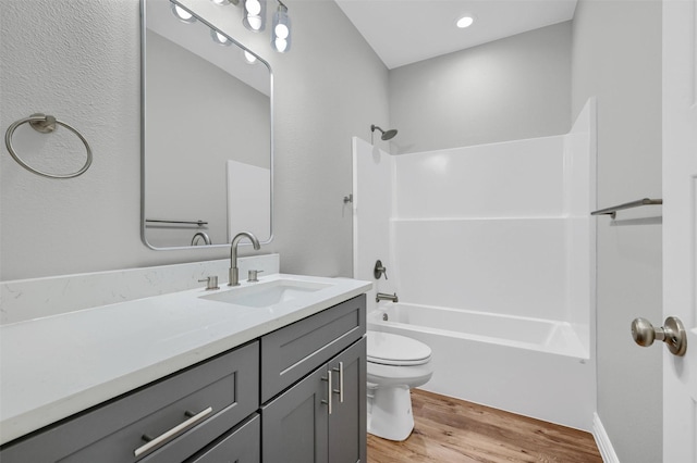 full bathroom featuring vanity, toilet, hardwood / wood-style floors, and  shower combination