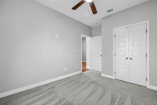 unfurnished bedroom featuring carpet floors, ceiling fan, and a closet