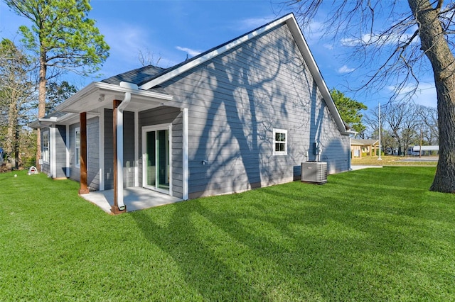 view of property exterior featuring cooling unit, a patio area, and a lawn