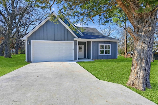 view of front facade with a garage and a front lawn