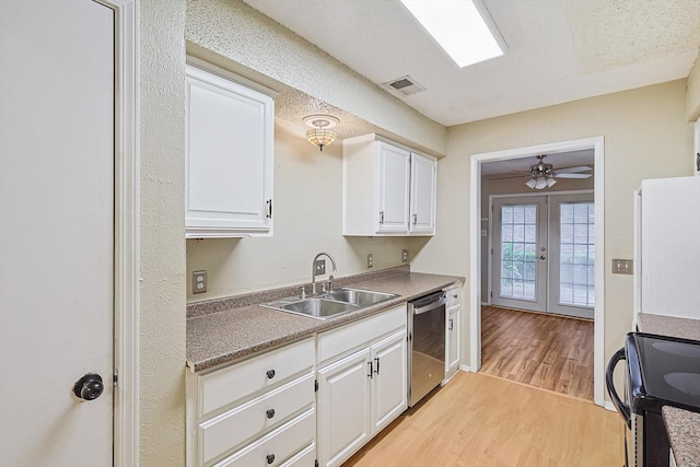 kitchen with french doors, white cabinets, light hardwood / wood-style flooring, dishwasher, and range