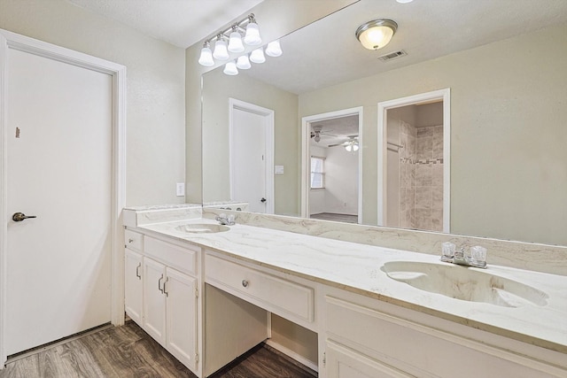 bathroom featuring hardwood / wood-style floors, vanity, and a textured ceiling