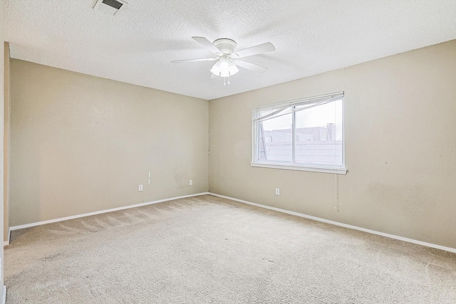 unfurnished room featuring a textured ceiling, carpet floors, and ceiling fan