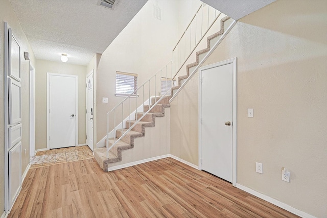 foyer featuring a textured ceiling and hardwood / wood-style flooring