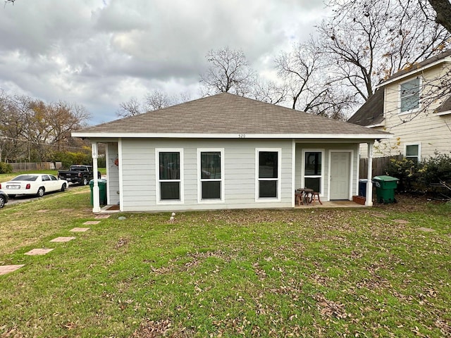 rear view of house with a yard