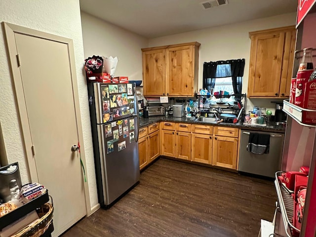 kitchen with dark hardwood / wood-style flooring, stainless steel appliances, and sink