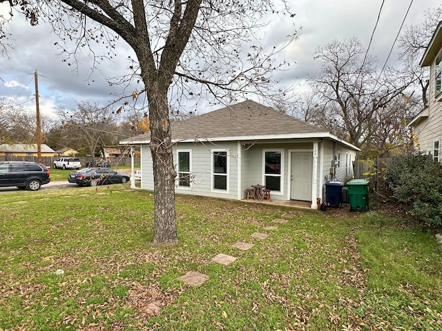 back of house with a lawn