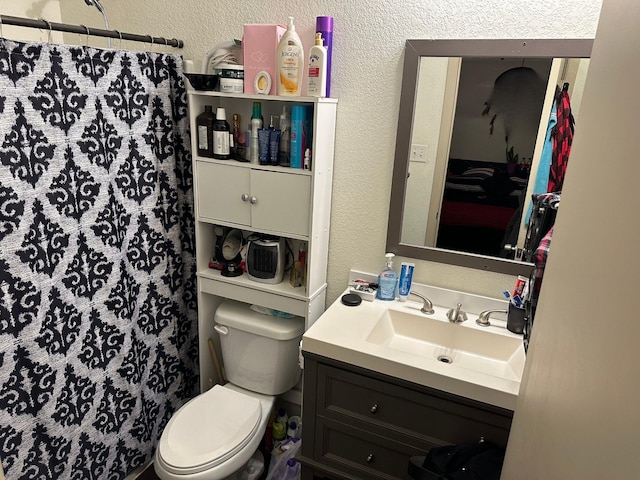 bathroom with a shower with curtain, vanity, and toilet